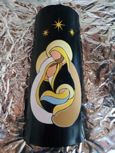 a wine bottle with the image of mary and baby jesus on it is wrapped in tin foil