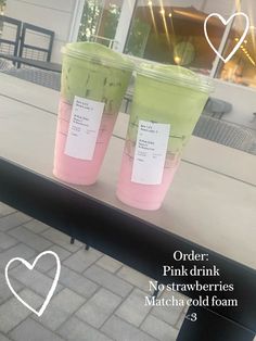 two plastic cups with pink and green drinks