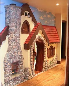 a fake house made out of rocks with a fire place in the front and side