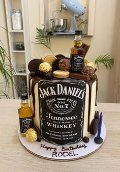 a birthday cake decorated with liquor bottles and chocolates