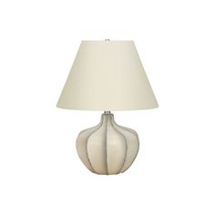 a lamp that is on top of a white table with a light shade over it