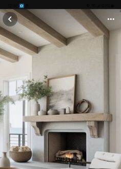 a living room filled with furniture and a fire place in the middle of a room