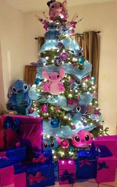 a christmas tree decorated with pink and blue presents