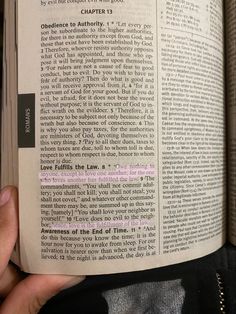 a person holding up a book with an article in it's center and the text underneath it