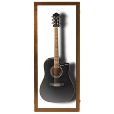 an acoustic guitar in a wooden frame on a white background with shadow from the wall