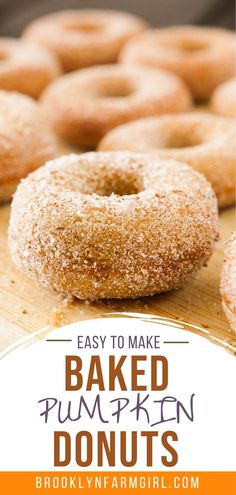 baked pumpkin donuts on a cutting board with the words easy to make baked pumpkin doughnuts