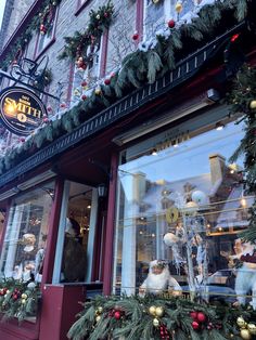 a store front with christmas decorations on the windows