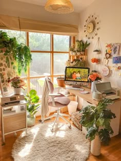 a home office with lots of plants in the window sill and on the desk