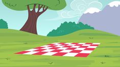 a red and white checkerboard is in the middle of a green field with trees