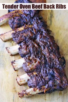 there is a large piece of meat on the cutting board with text overlay that says tender oven beef back ribs