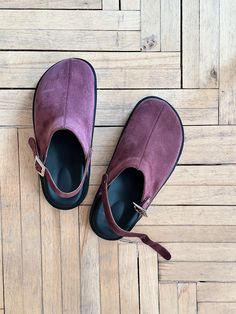 Barefoot shoes with a movable strap. You can wear these burgundy suede clogs either with a strap around the heel for better fixation, securing it around the ankle, or at the front, like mules. Crafted in suede, featuring a genuine leather lining inside. A geometric buckle serves as the main accent. Light polyurethane voluminous anatomic sole. Round toe. PRODUCT INFORMATION Upper: suede Lining: leather Sole: orthopaedic polyurethane sole Colour: burgundy * the model is undersized * every pair of shoes is handcrafted CUSTOMIZATION OPTIONS - In terms of availability, if the size you need is in stock, we can dispatch your order within 1-2 days. However, if the size is out of stock or requires a custom order, it may take up to 2 weeks to make the clogs, followed by an additional 7-14 days for s Womens Clogs And Mules, Clogs Women, Clogs And Mules, Suede Clogs, Orthopedic Shoes, Purple Suede, Barefoot Shoes, Womens Clogs, Clogs Shoes