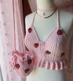 a pink knitted bralet and matching purse