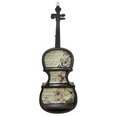 an old violin with roses on it hanging from a hook in front of a white background