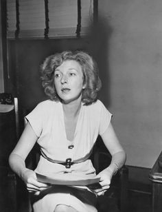 black and white photograph of woman sitting on chair