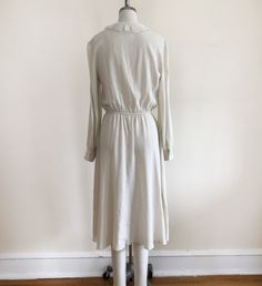 "Long-sleeved, ivory dress with pintucks and embroidered lace collar, from the 1980s. Bust measures 19\" (48.5 cm) flat across and waist measures 12-17.5\" (30.5-44.5 cm) flat across. The dress is 45\" (114 cm) in length. Original size is an 11. Cotton blend." Cream Long Sleeve Retro Vintage Dress, Vintage Cream Prairie Dress For Daywear, Retro Cream Vintage Dress With Long Sleeves, Cream Retro Long Sleeve Vintage Dress, Retro Cream Long Sleeve Vintage Dress, Vintage Long Sleeve Cream Prairie Dress, Cream Prairie Dress With Lace Trim For Daywear, Beige Long Sleeve Vintage Dress For Formal Occasions, Elegant Prairie Dress For Fall Daywear