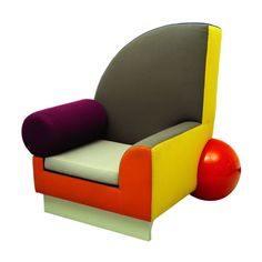 a colorful chair with an apple sitting on it's back end next to the seat