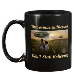 a black coffee mug with the words, the cosmos and beyond don't stop believing