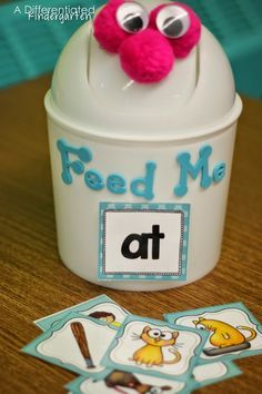 a close up of a cup on a table with cards and a stuffed animal in it