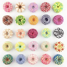 an assortment of donuts with different designs on them are displayed in a white frame