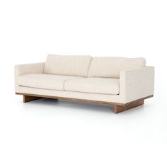 a white couch sitting on top of a wooden frame