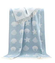 a blue and white towel with shells on it