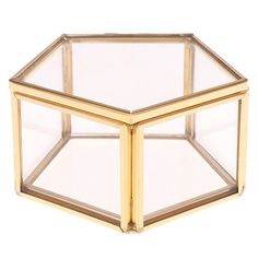 an octagonal glass box with gold trimmings on the top and bottom, set against a white background