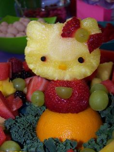 a hello kitty figurine made out of fruits and vegetables