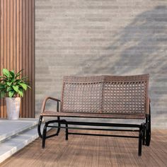 a wooden bench sitting on top of a hard wood floor next to a planter