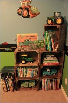 a book shelf filled with lots of books next to a wall mounted toy truck and tractor