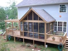 a house with a screened porch in the front yard