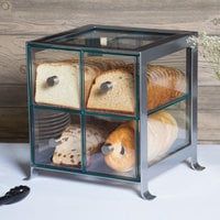 a glass box with bread and rolls in it