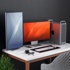 an apple computer sitting on top of a desk next to a keyboard and monitor screen