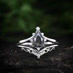 a white gold engagement ring with a pear shaped diamond