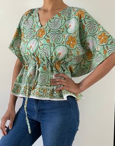 Blouses are made of Indian hand block cotton fabric in beautiful prints. Total 6 prints available, choose your option from drop down menu!  It is made to fit few sizes of 2 to 12 easily, please check measurements!  Great for work/outings/vacations.  Length - 21.5" Bust - fits up to 43" of bust all around.  Waist - fits up to 37" of waist all around. My bust is 36" and waist is 28" for reference. Caftan blouse has drawstring waist for a cinched waist look. You can adjust accordingly!! If you like Patterned Short Sleeve Cotton Tops, Patterned Cotton Short Sleeve Tops, Green Cotton V-neck Blouse, Bohemian Cotton Top With Relaxed Fit, Casual Tops With Pattern Prints, Bohemian Cotton Top, Multicolor Printed Cotton Tops, Green Printed Tops For Vacation, Patterned Cotton Tops With Floral Print