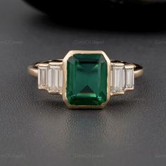 Five Stone Diamond Ring, Moissanite Diamond Ring, Lab Sapphire Green Emerald Cut Engagement Ring, Baguette Cut Moissanite Bezel Set Anniversary Ring, Five Stone Wedding Gift For Her ▶Center Stone Details: Diamond Type: Lab Sapphire Green  Diamond Shape: Emerald cut Diamond Color: Green Diamond Clarity: VVS Diamond Dimension: 9*7 mm Diamond Weight: 2.50 CT Approx ▶Side Stone Details: Diamond Type: Moissanite Diamond Shape: Baguette cut Diamond Color: Colorless Diamond Clarity: VVS Diamond Dimension: 5*2.50 mm X 4*2 mm Diamond Weight: 0.66 TCW Approx Band Width: 1.80 mm Approx Can Be Customized in 10/14/18k Yellow/Rose/White Gold And Platinum Or Sterling Silver. For More Video And Image Please Message us. Why buy Moissanite over Diamond? ● Moissanite is pocket-friendly, it is almost 1/10 of Emerald Engagement Ring Bezel, Wooded Wedding, Green Emerald Engagement Ring, Engagement Ring Baguette, Delicate Fine Jewelry, Engagement Ring Bezel, Emerald Cut Engagement Ring, Ring Baguette, Bezel Engagement Ring