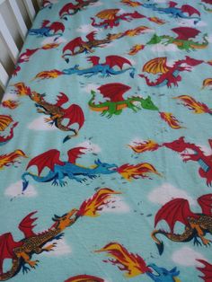 a crib bed with a dragon print on it