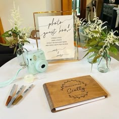 a table topped with a notebook and flowers