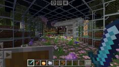 the inside of a building with lots of flowers in it and plants growing on the ground