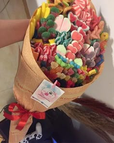 a person holding a bouquet of colorful candies