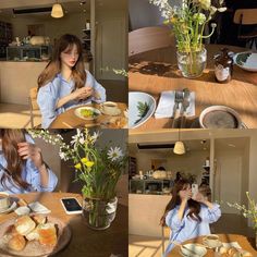 a woman sitting at a table with food and flowers in front of her on the phone