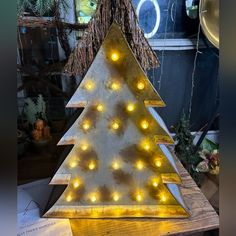 a lighted wooden christmas tree with yellow lights