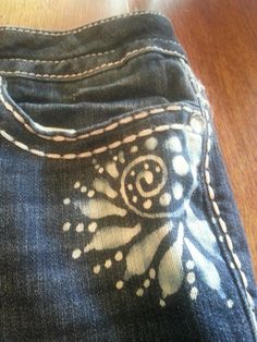 a pair of blue jeans with white designs on them