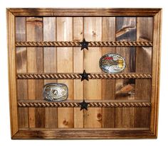 a wooden display case with three belts and two stars on the bottom, one belt