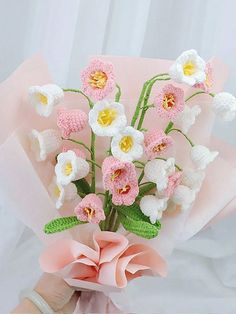 a bouquet of crocheted flowers in pink and white