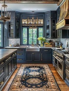 a kitchen with blue cabinets and an area rug