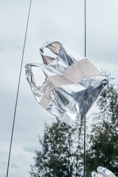 there is a kite that has been made out of aluminum foil and it looks like an origami bird