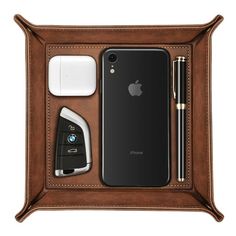 an iphone and other items in a leather case