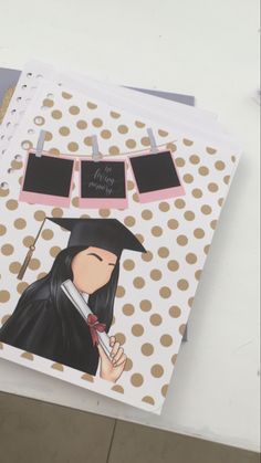 a notebook with an image of a woman in graduation cap and gown holding a pen