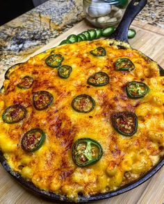 a pizza sitting on top of a pan covered in cheese and toppings next to a spatula