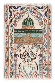 an intricately designed rug with blue, red and green designs on the front side